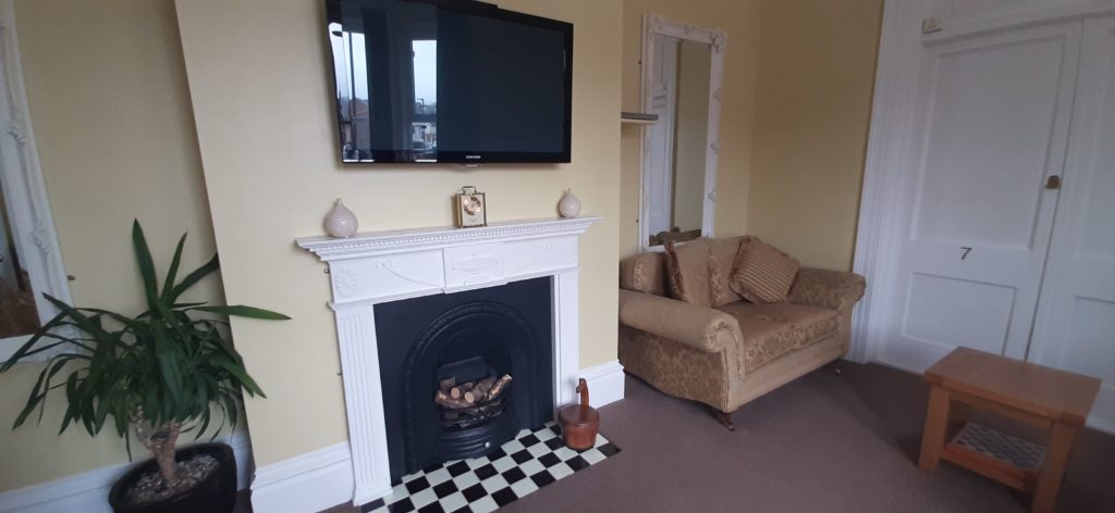 Showing the TV, Fireplace & Sofas in the Guest Lounge